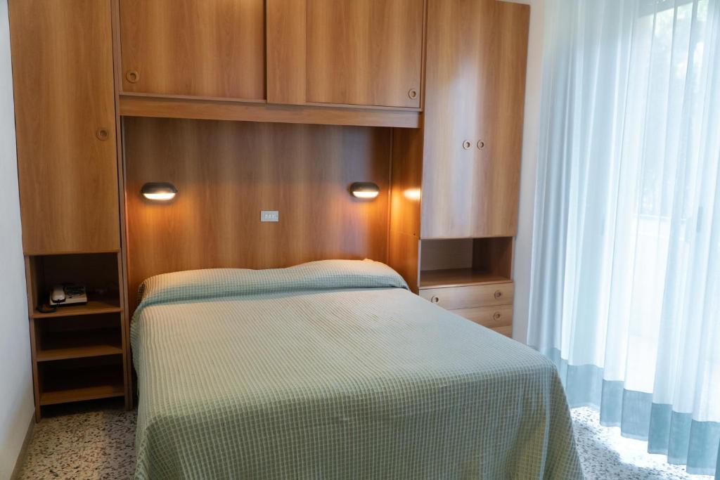 Postel nebo postele na pokoji v ubytování Hotel Cinzia