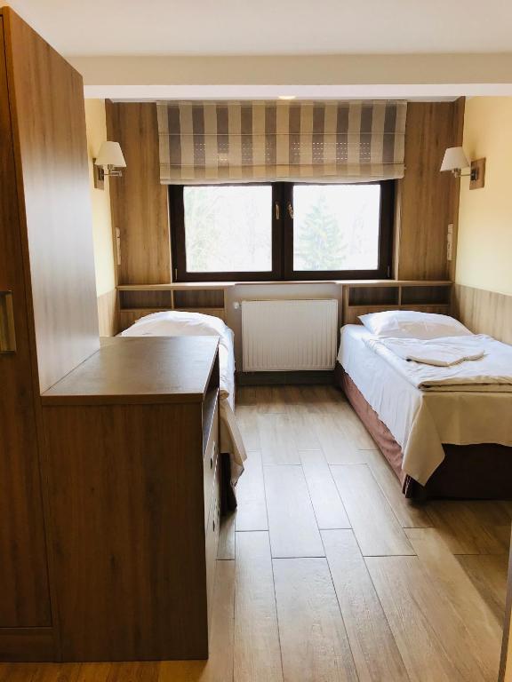 Postel nebo postele na pokoji v ubytování Hotel Korona