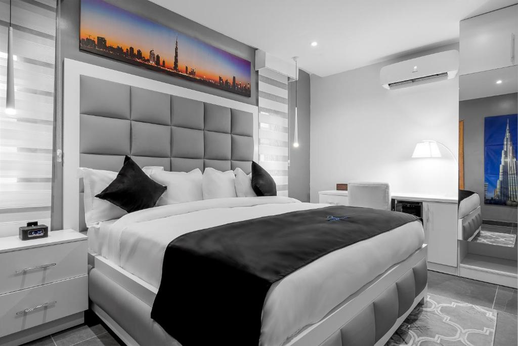 a bedroom with a large bed with a large headboard at Villa Monument Hotel in Lagos