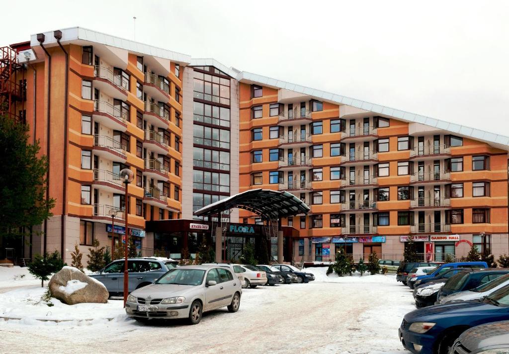 a parking lot in front of a large building at Apartments Flora-Daisy in Borovets