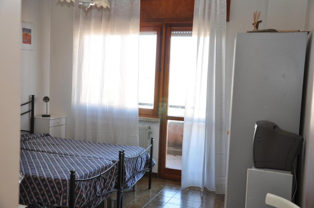 a small bedroom with a bed and a window at Giangurgolo B&B in Rende