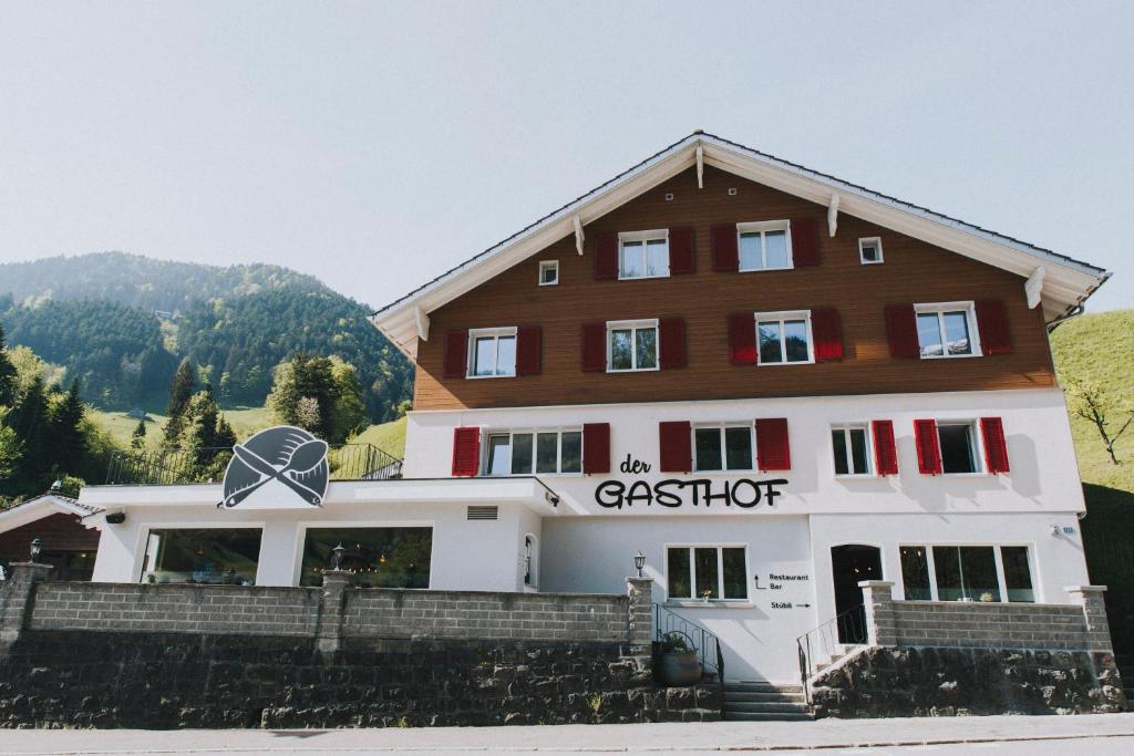 a large white building with a sign on it at der GASTHOF in Bürglen