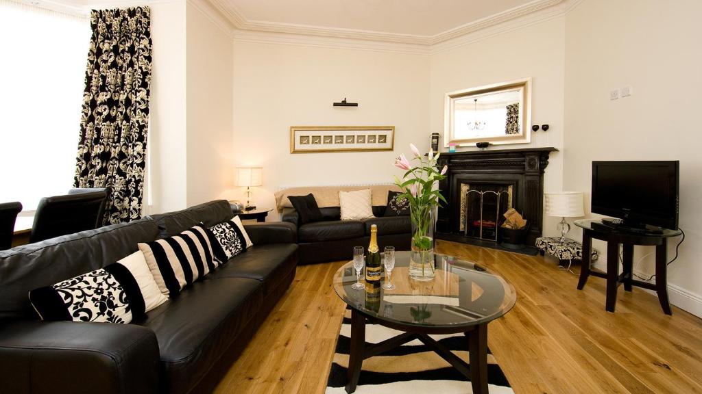 a living room with a black couch and a fireplace at Dublin Vacation Rentals in Dublin