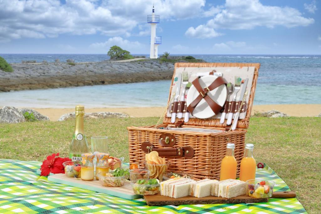 a picnic basket with food and drinks on the beach at Sheraton Okinawa Sunmarina Resort in Onna
