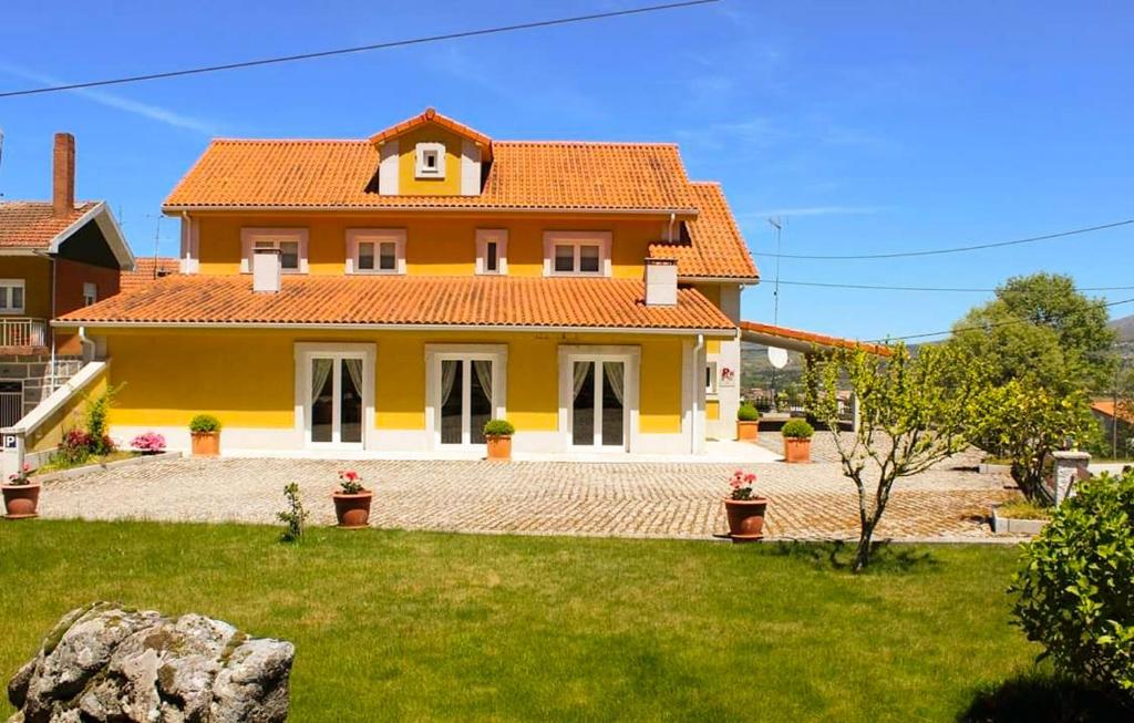 a yellow house with an orange roof at Casa Santa Catarina in Montalegre