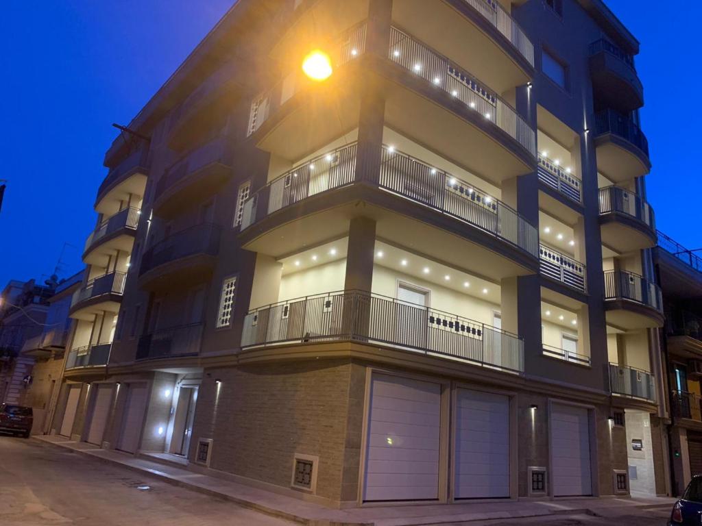 un edificio de apartamentos alto con luces encendidas en Palazzo Ducale, en San Severo