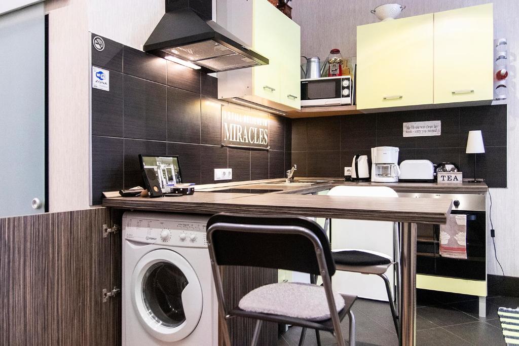 a kitchen with a washing machine and a washer at Pipa Apartment in Budapest