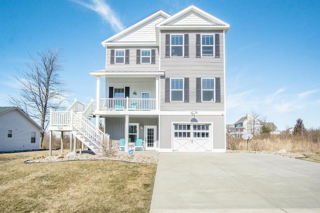 a large white house with a porch and a driveway at Blue Haven in South Haven