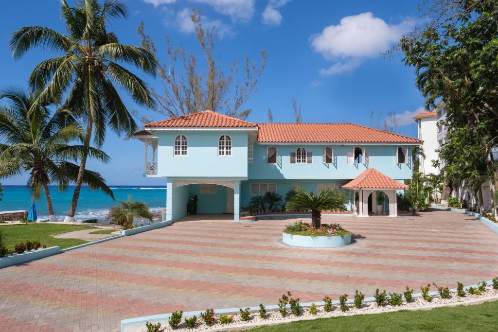 a villa with a view of the ocean at Edgewater Beach Villa - Beach Front, Close to All Attractions in St Mary