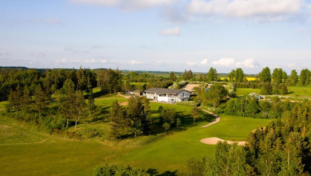 an aerial view of a house on a golf course at Hjarbæk Fjord Golfcenter in Skals