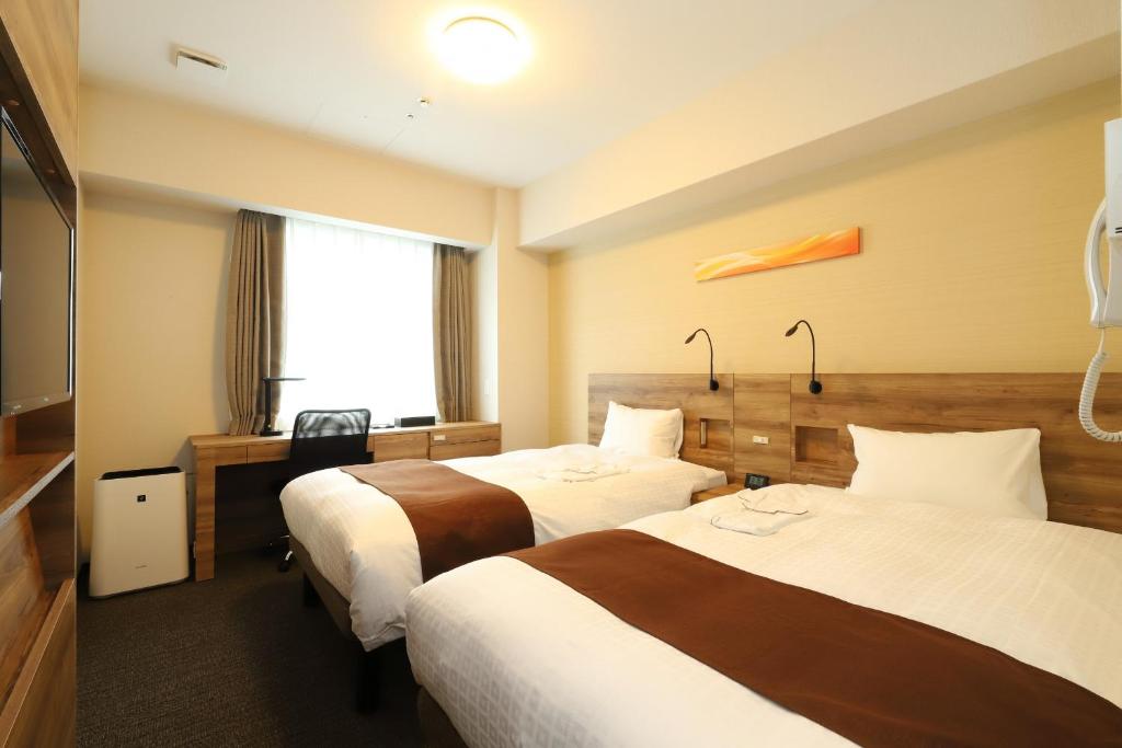 Postelja oz. postelje v sobi nastanitve Smile Hotel Premium Osaka Higashishinsaibashi