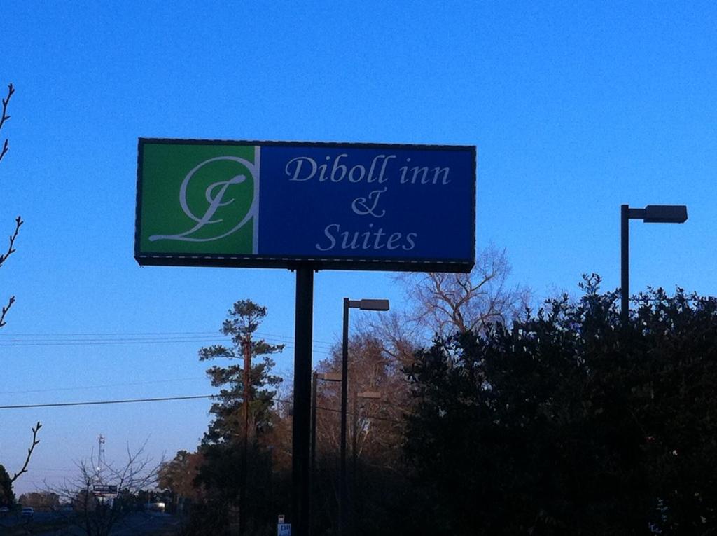 a sign for aothoth inn and suites on a street at Diboll Inn and Suites in Diboll