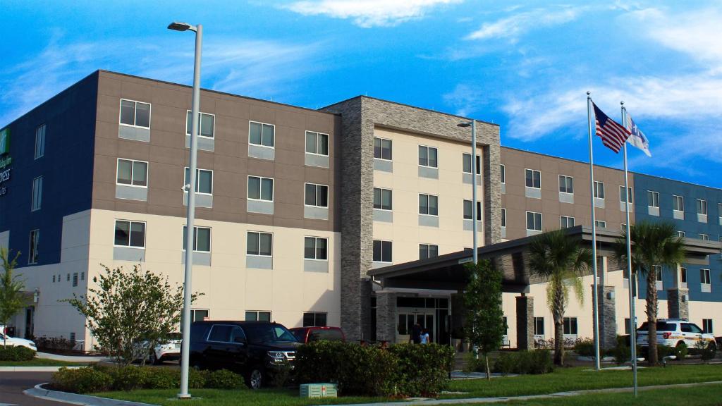 un edificio con una bandera americana delante de él en Holiday Inn Express & Suites - Jacksonville W - I295 and I10, an IHG Hotel en Jacksonville