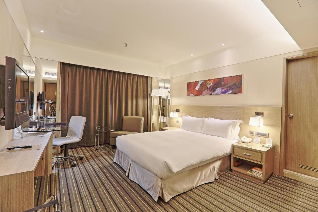 台北市にあるサントス ホテルのベッドとデスクが備わるホテルルームです。