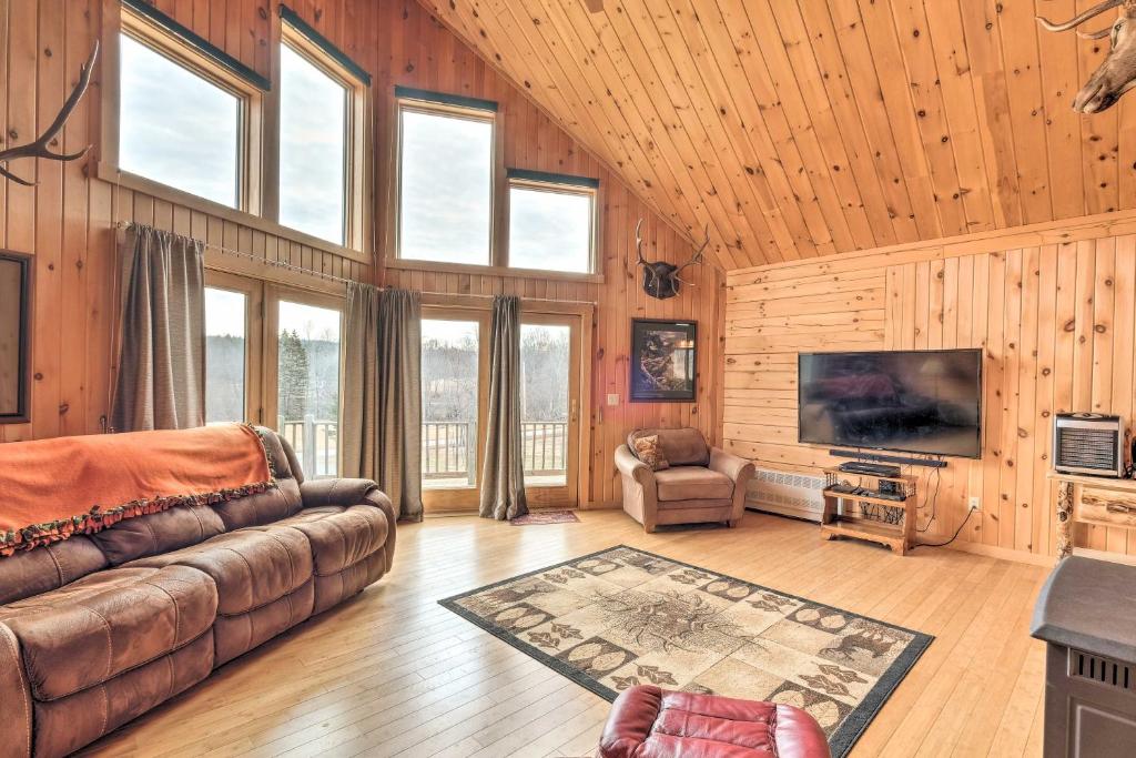 a living room with a couch and some windows at Family-Friendly Troy Getaway with Furnished Deck! in Unity