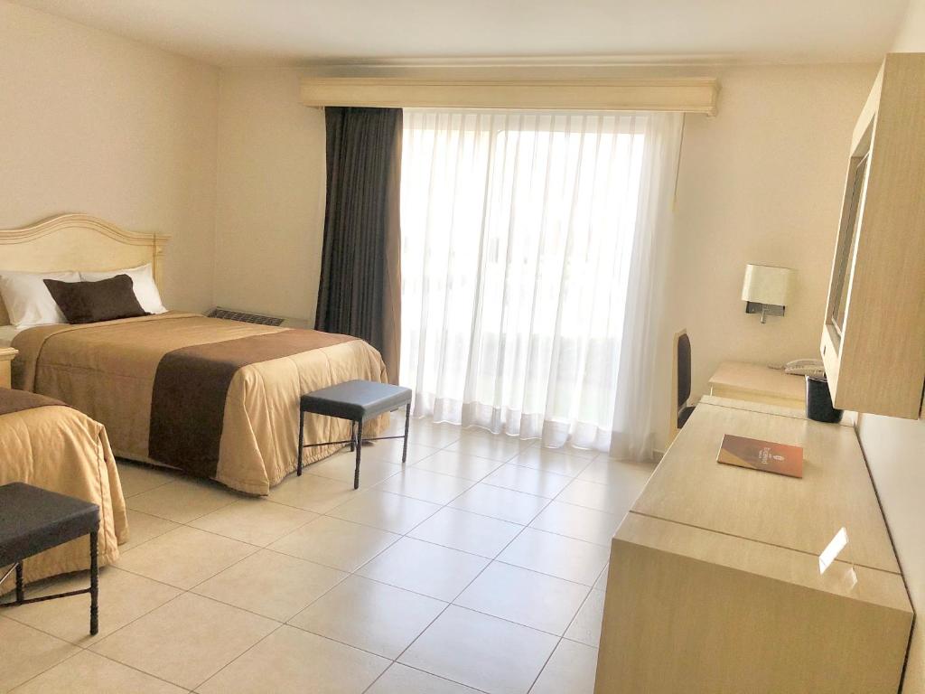 Postel nebo postele na pokoji v ubytování Hotel Real de Minas Bajio