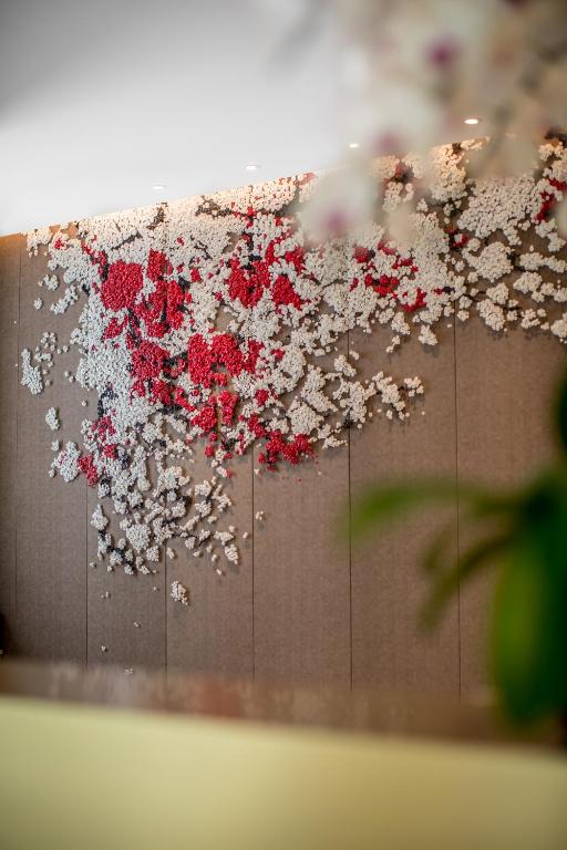 a wall with red and white flowers on it at Sincere Residence Changfeng - Changfeng Ecological Business District - Near Exit 3 of Changfeng Park Station on Subway Line 15 in Shanghai