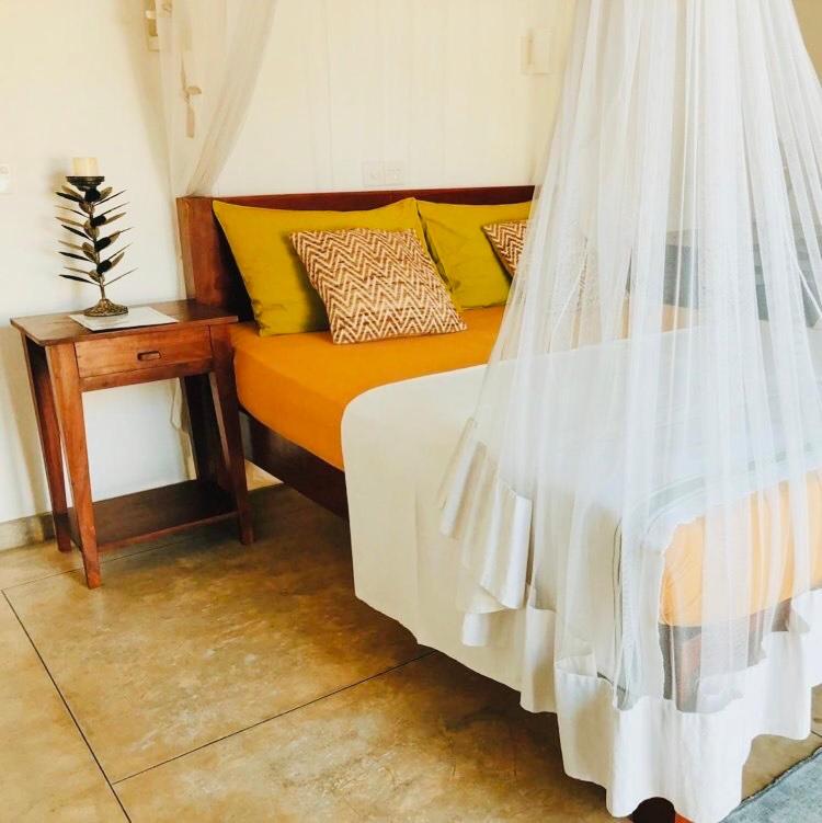 Postel nebo postele na pokoji v ubytování Jasmine Garden Beach Guest House