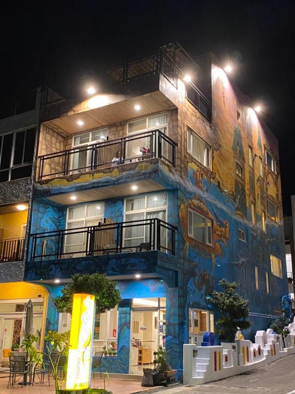 a building with a painting on the side of it at LoveSea 126 Beach Inn in Kenting