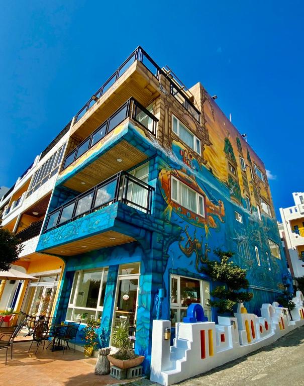 a building with a painting on the side of it at LoveSea 126 Beach Inn in Kenting
