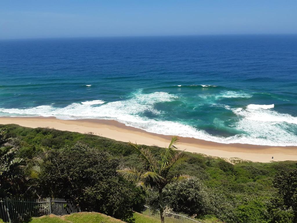 an aerial view of a beach and the ocean at At the Sea's Edge in Durban