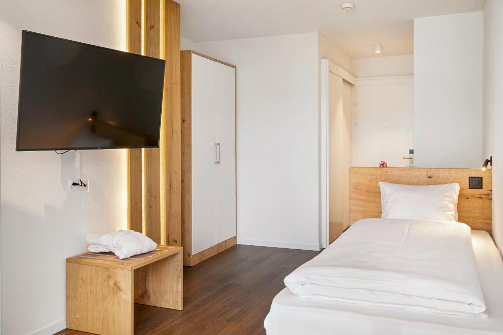 Postel nebo postele na pokoji v ubytování Hotel Rössli Gourmet & Spa