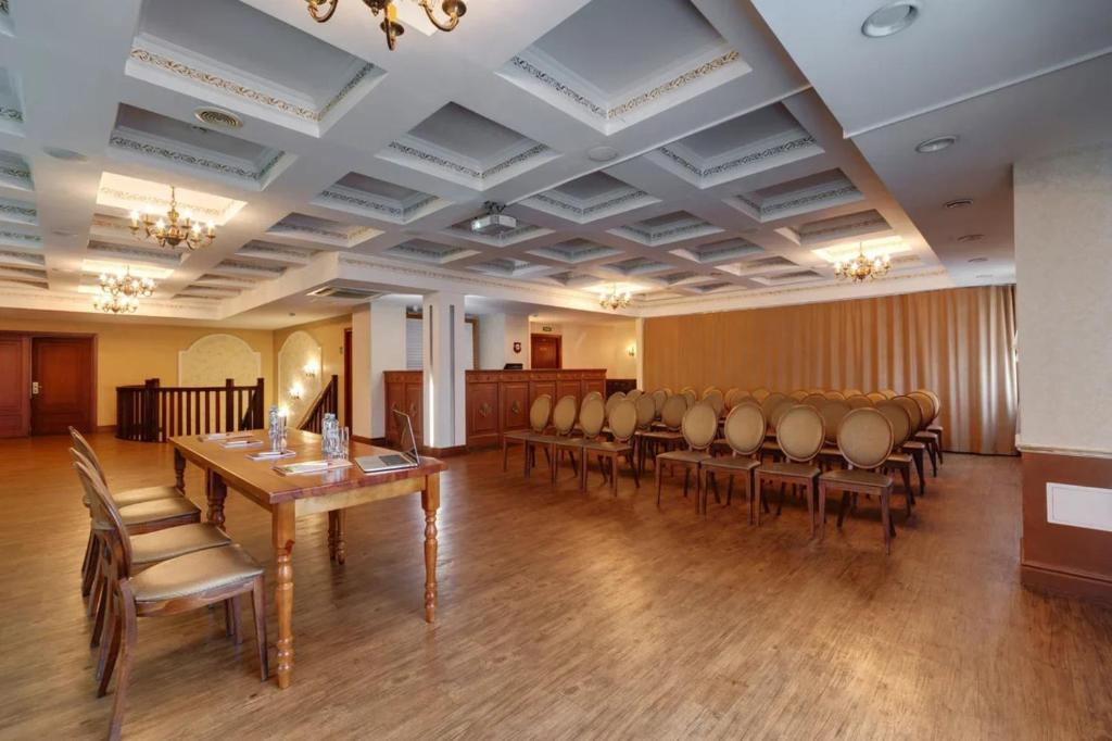 a conference room with chairs and a table and a podium at Grand Peterhof Spa Hotel in Petergof