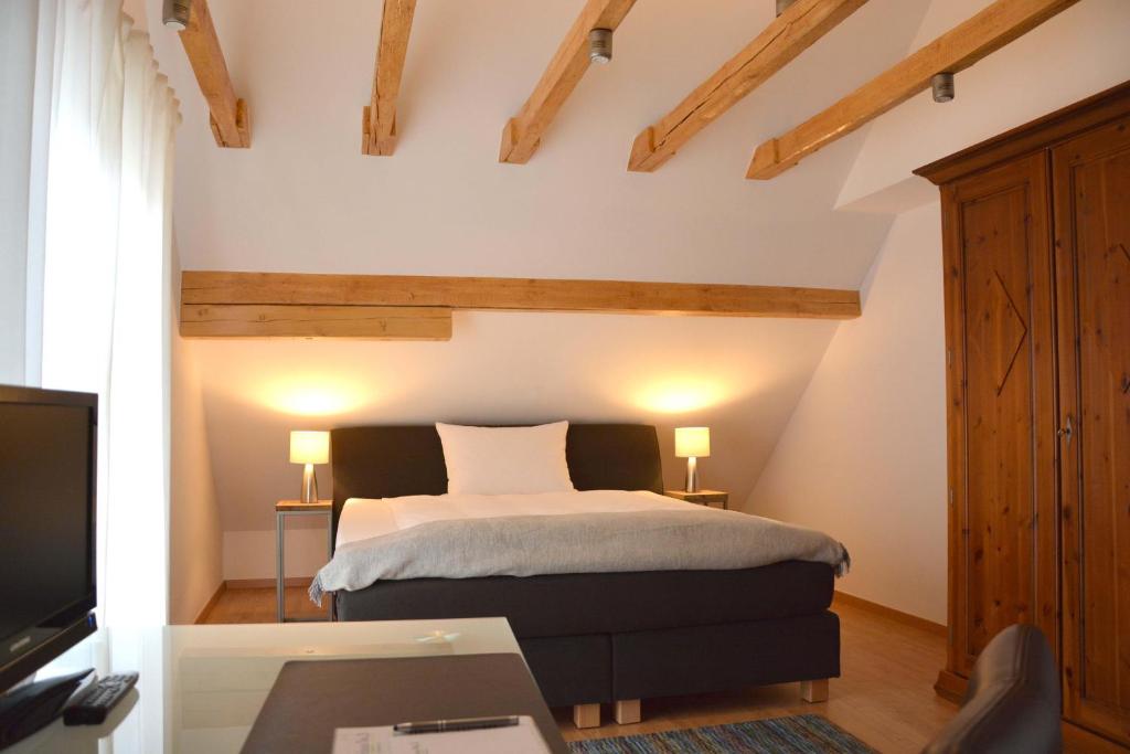 a bedroom with a bed and a desk and a tv at Gästehaus No. 3 in Simmern