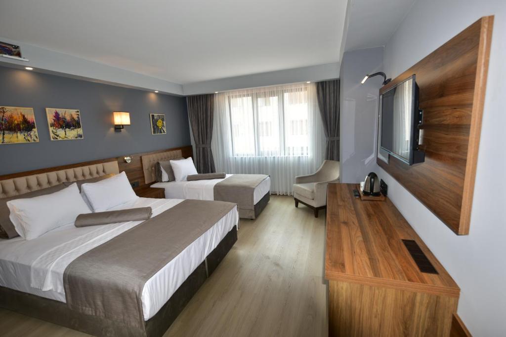 Postel nebo postele na pokoji v ubytování Oytun Park Hotel