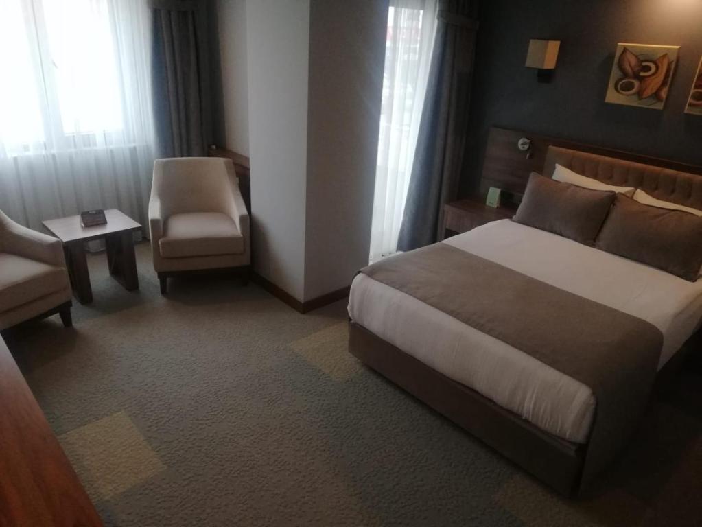 Postel nebo postele na pokoji v ubytování Oytun Park Hotel