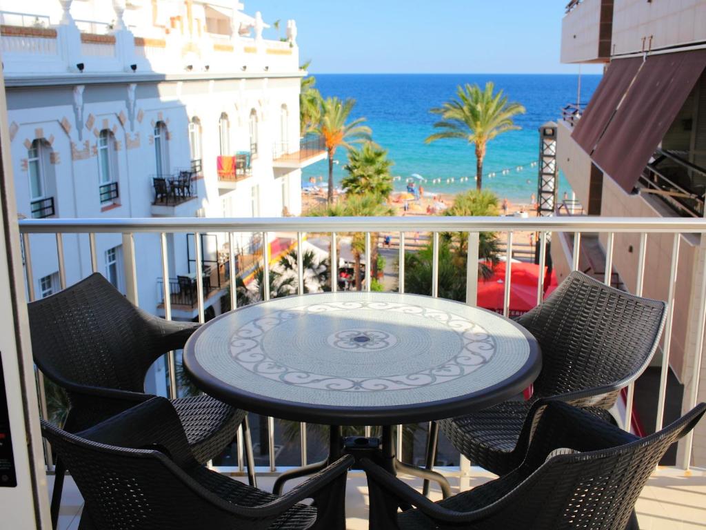 a table on a balcony with a view of the ocean at Apartment Giner by Interhome in Benidorm