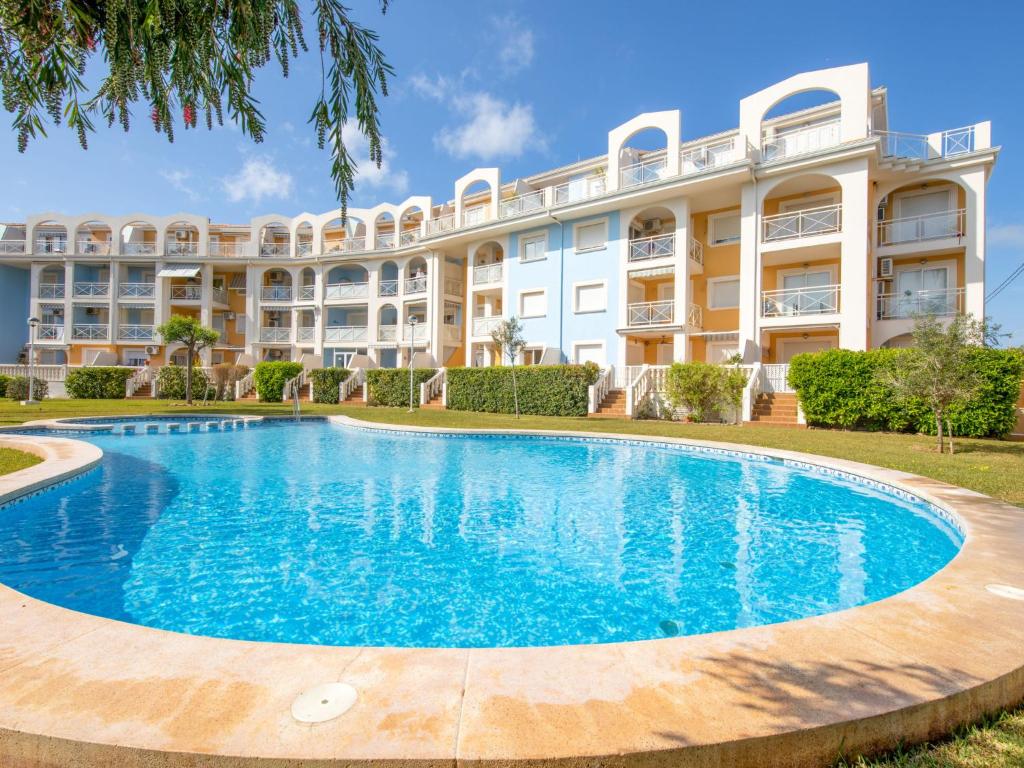 an apartment building with a large pool in front of it at Apartment Bahia Blanca-1 by Interhome in Denia