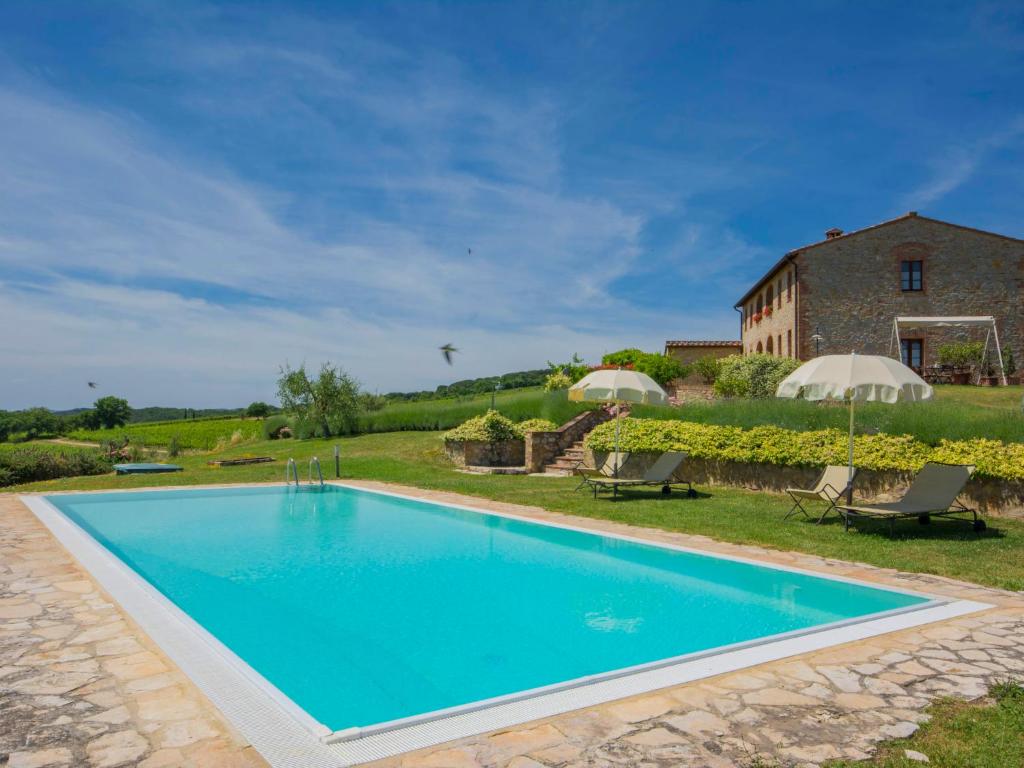 an image of a swimming pool in front of a house at Holiday Home Vanessa by Interhome in Castelnuovo Berardenga