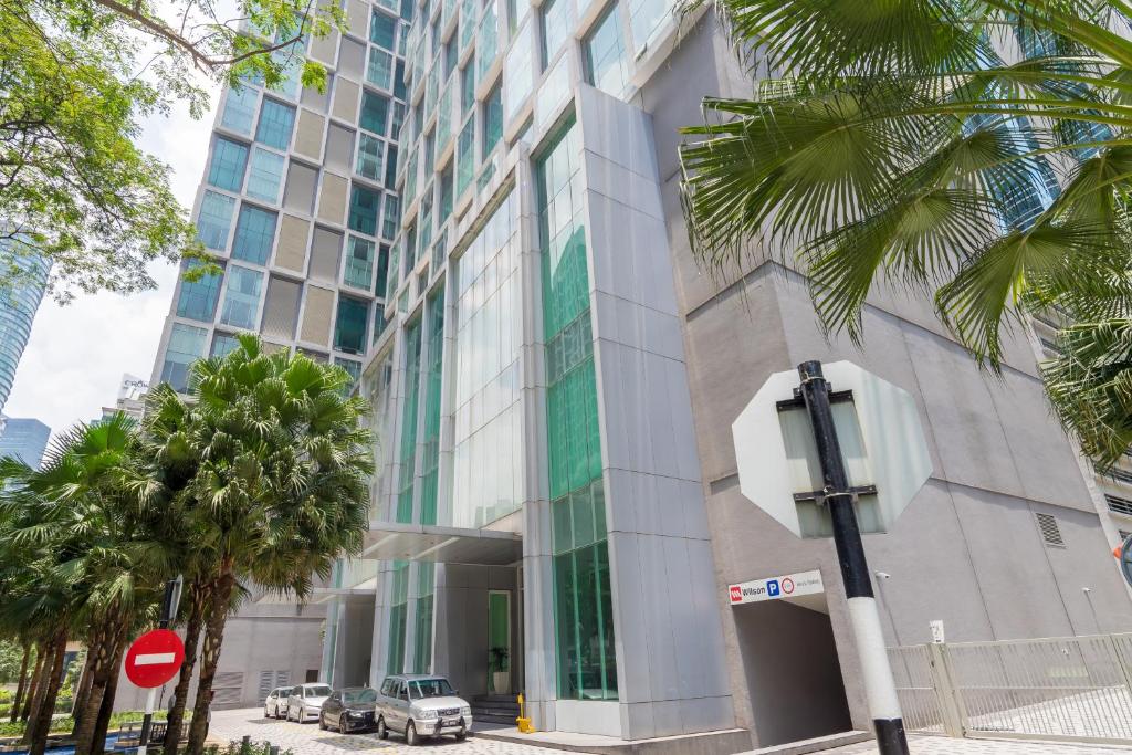 a building with a car parked in front of it at Kuala Lumpur City Centre Apartments in Kuala Lumpur