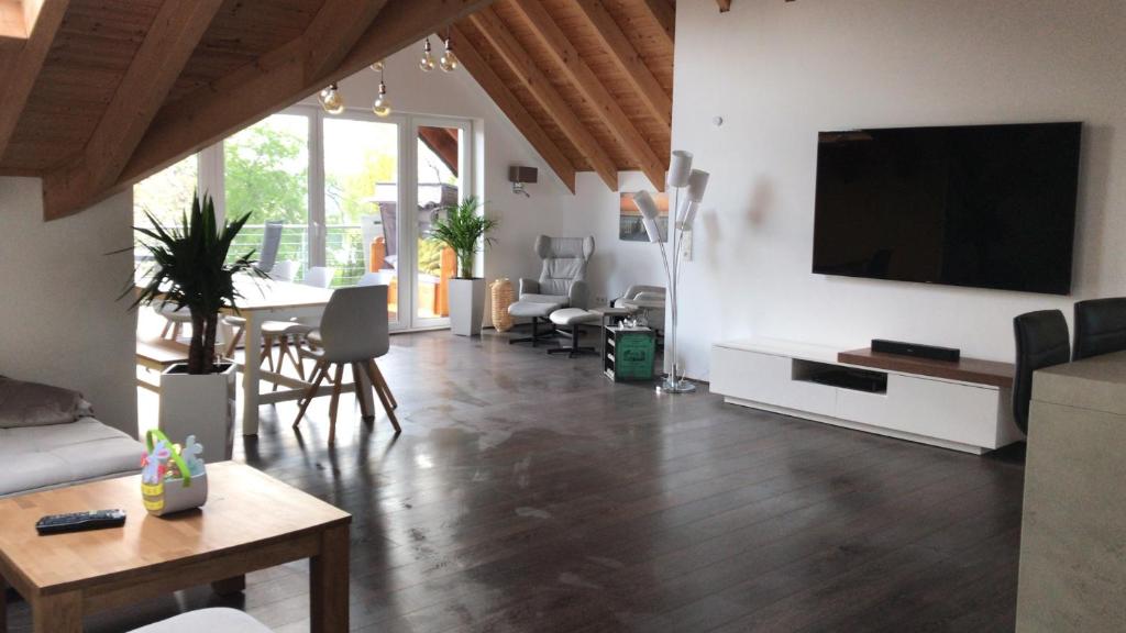 a living room with a flat screen tv on a wall at Stadtvilla Intzeplatz - Apartment Norderney in Remscheid