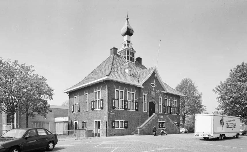 a large building with a flag on top of it at Herberg de Griffioen in Wolphaartsdijk