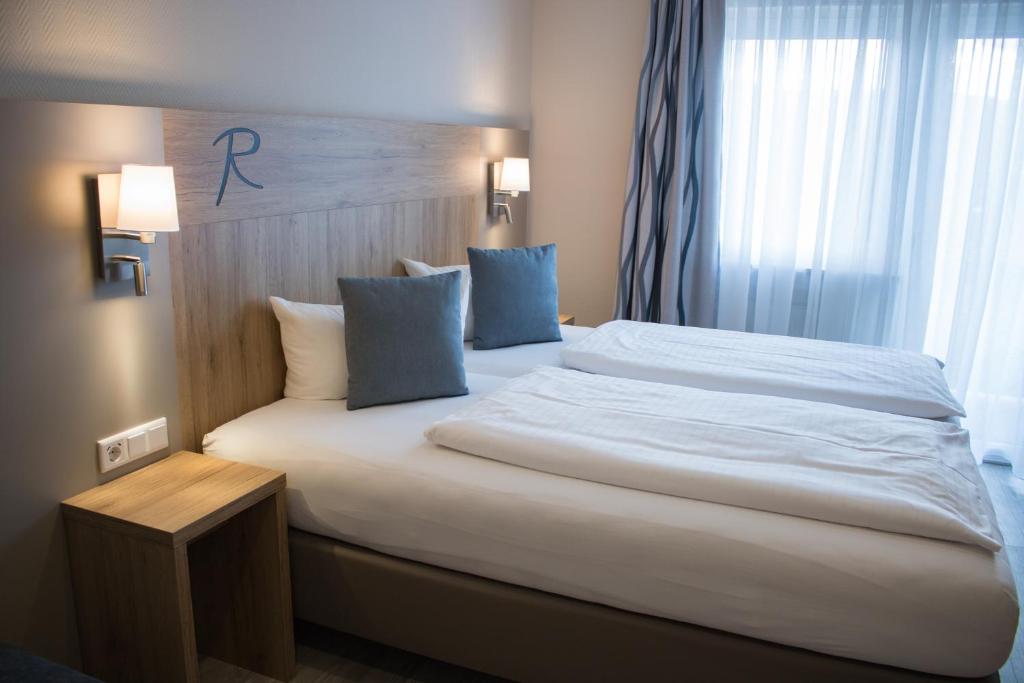 Postel nebo postele na pokoji v ubytování Hotel Rosenbusch