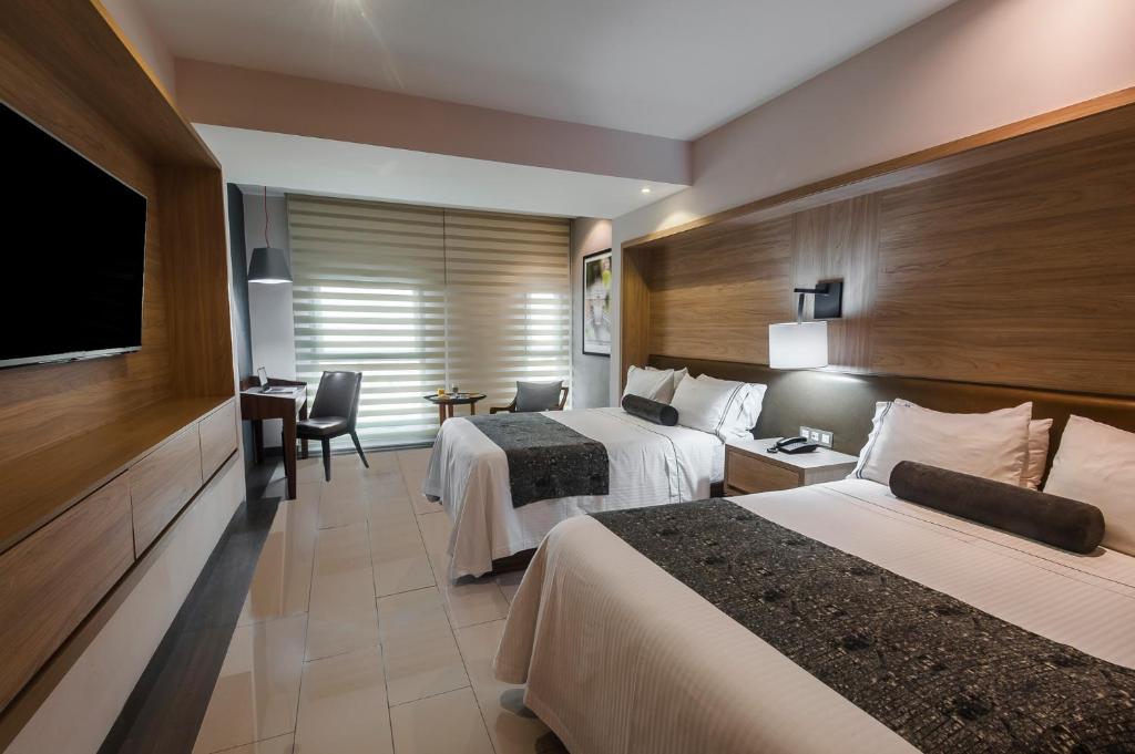 Postel nebo postele na pokoji v ubytování Hotel Real Maestranza