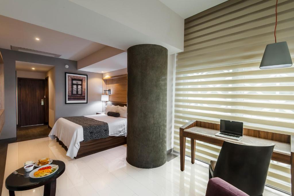 Postel nebo postele na pokoji v ubytování Hotel Real Maestranza