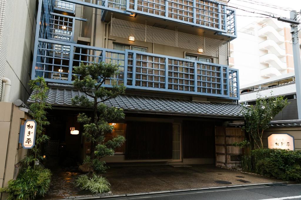 a building with blue balconies on the side of it at Kyonoyado Kagihei in Kyoto