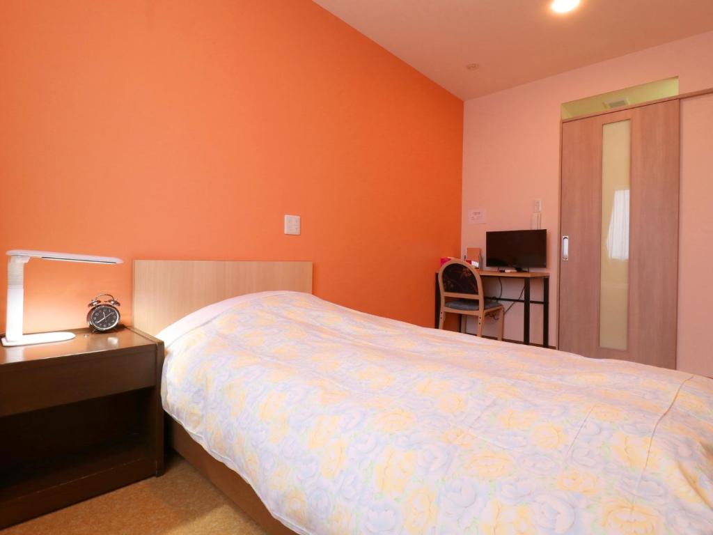 Postel nebo postele na pokoji v ubytování Hotel Asahi Grandeur Fuchu