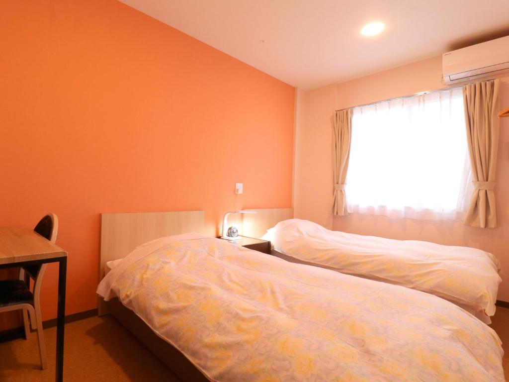 Postel nebo postele na pokoji v ubytování Hotel Asahi Grandeur Fuchu