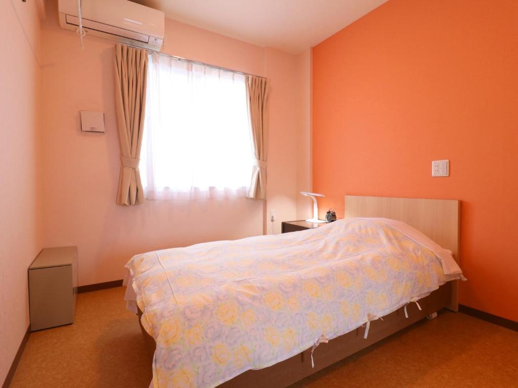 Postel nebo postele na pokoji v ubytování Hotel Asahi Grandeur Fuchu