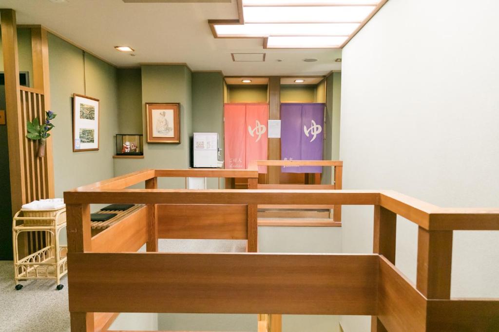 a waiting room with colorful doors and tables at Kyonoyado Kagihei in Kyoto