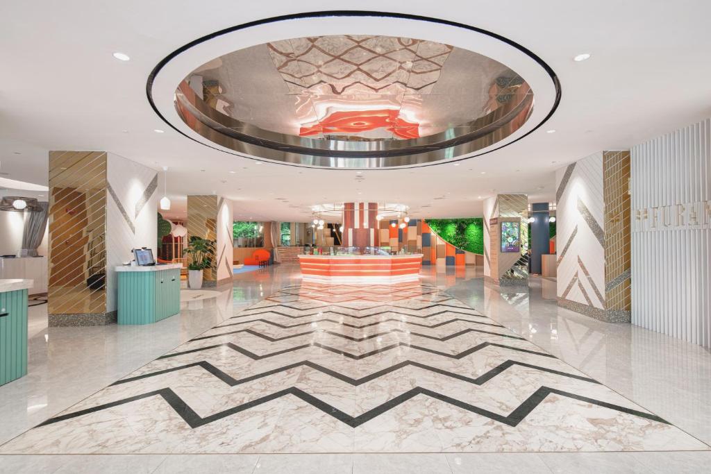 a lobby with a large rug on the floor at Furama RiverFront in Singapore