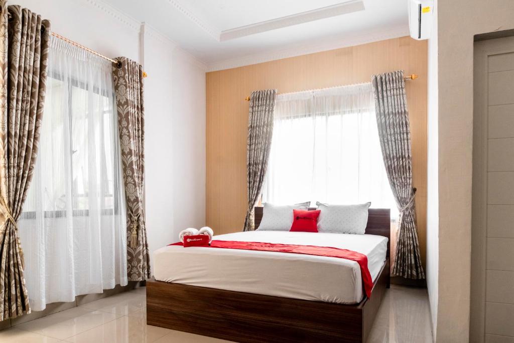 sypialnia z łóżkiem i oknem w obiekcie RedDoorz Syariah near Stadion Teladan Medan w mieście Medan