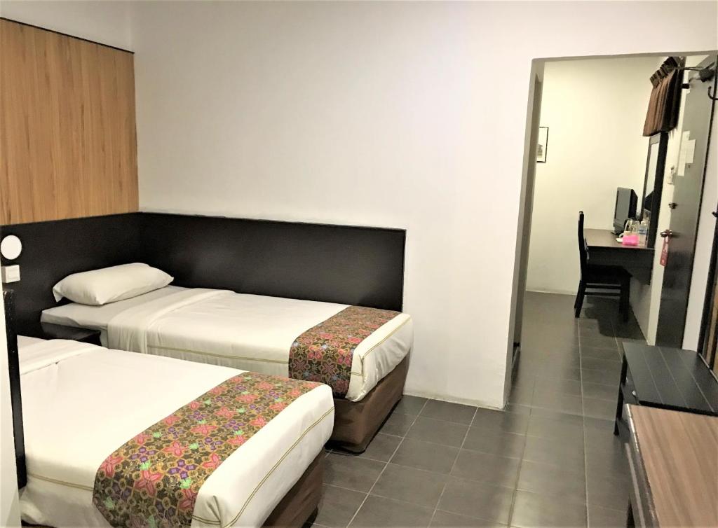 Postel nebo postele na pokoji v ubytování Sipadan Inn 1