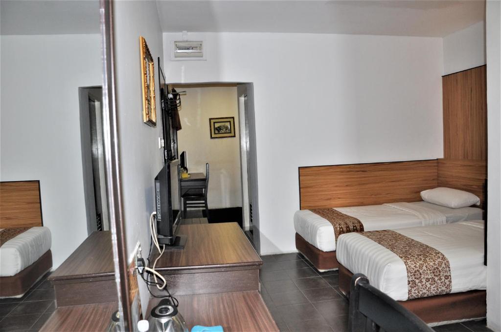 Postel nebo postele na pokoji v ubytování Sipadan Inn 1