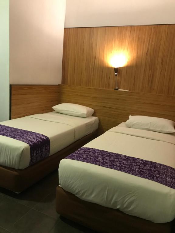 Postel nebo postele na pokoji v ubytování Sipadan Inn 1