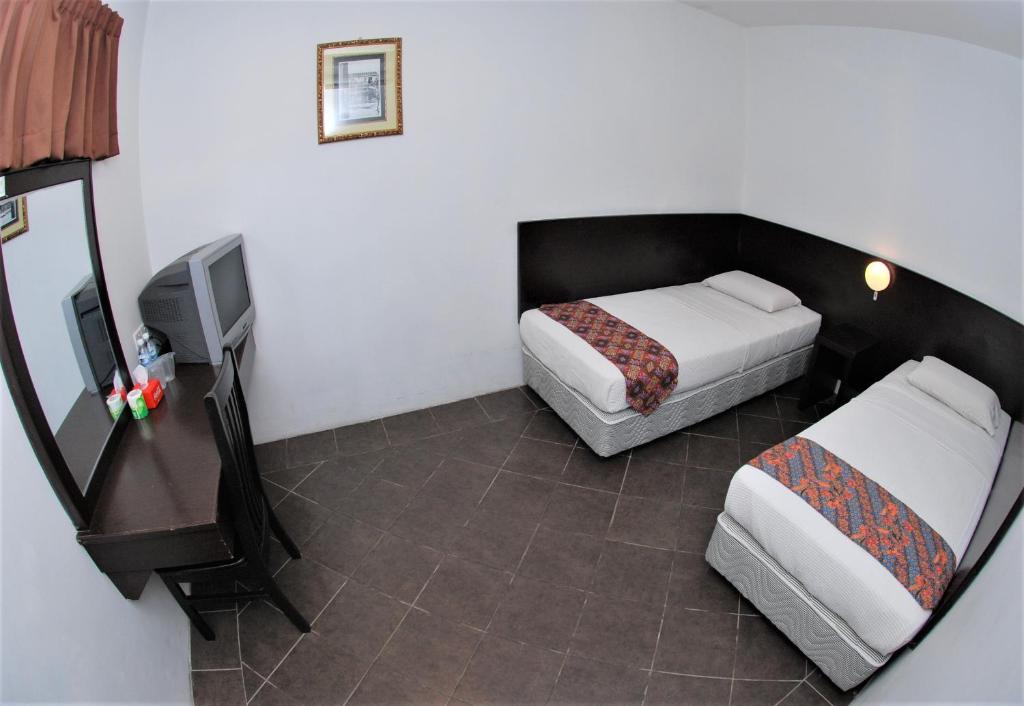 Postel nebo postele na pokoji v ubytování Sipadan Inn 1